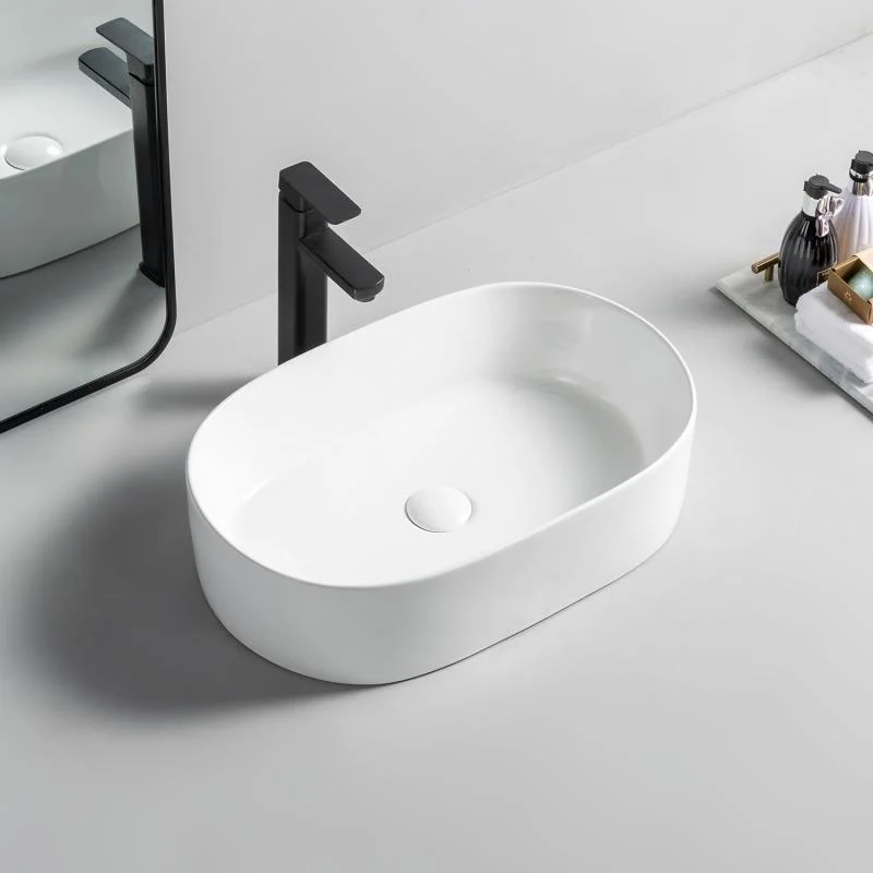 Lavoar oval Arezzo DAYTON, din porțelan, montaj pe blat, 56×36,5cm – alb